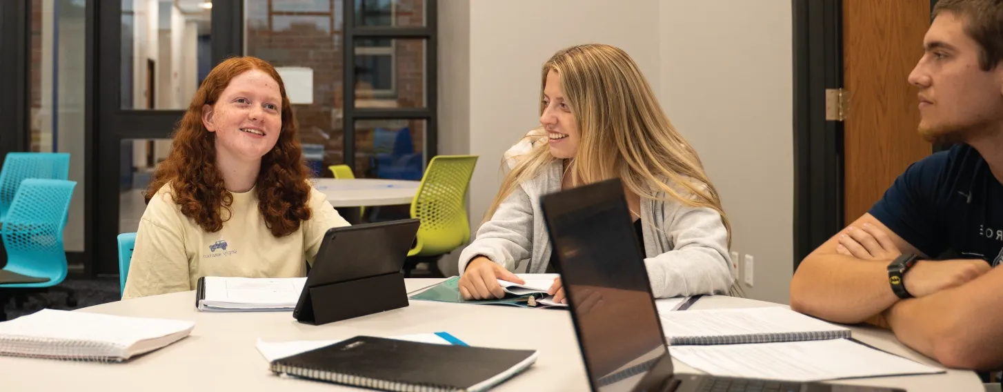 Students working together in a small group at a table.